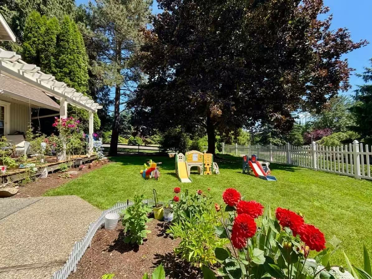 Flowers, lawn and children's play equipment in Lily's garden