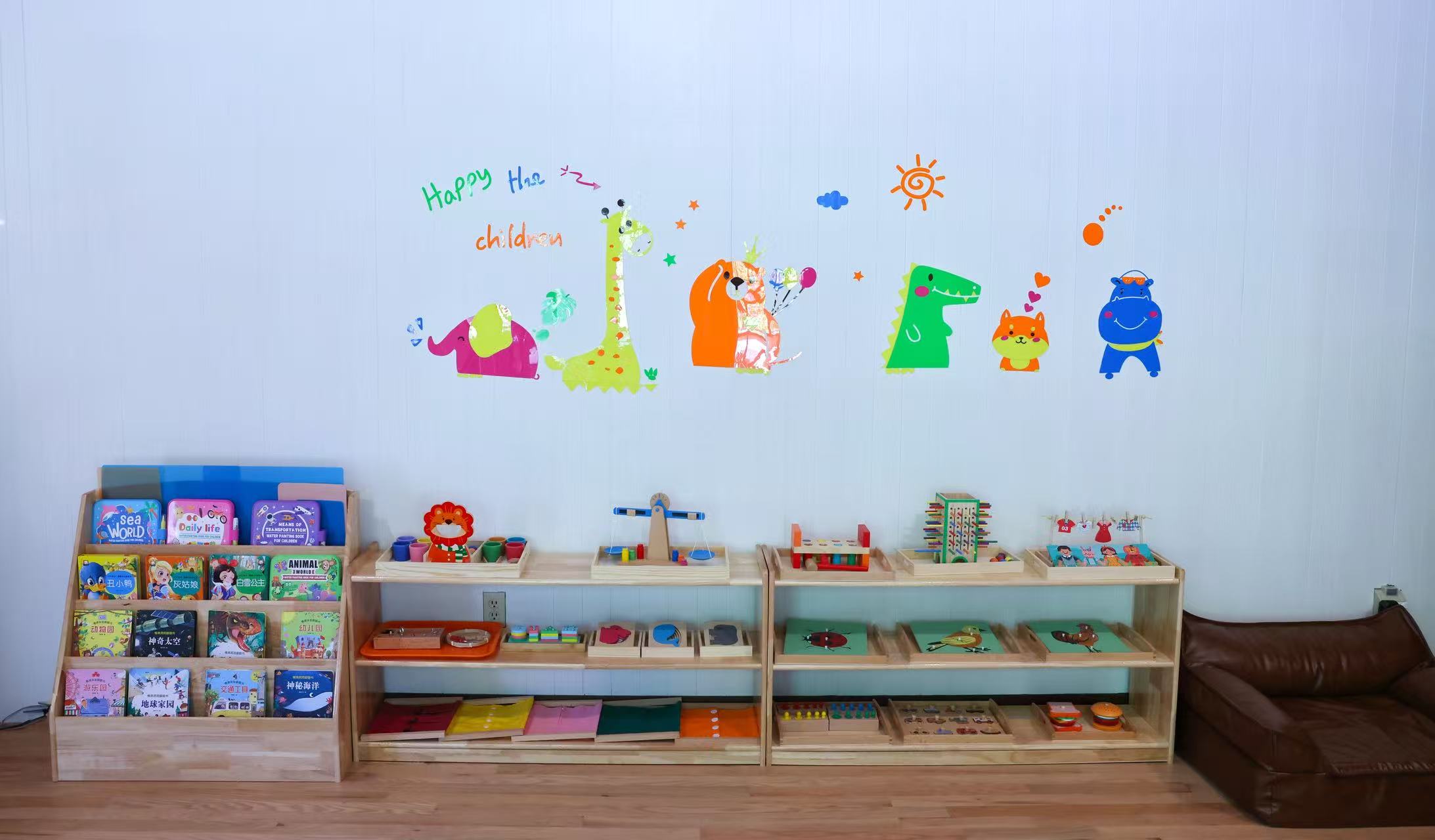 Books and hands-on learning materials on low wooden shelves