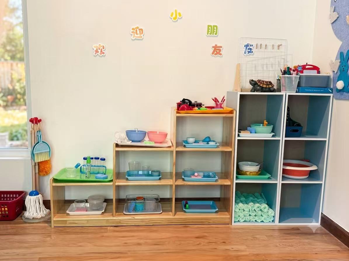 Small trays, bowls, and practical-life materials arranged on shelves
