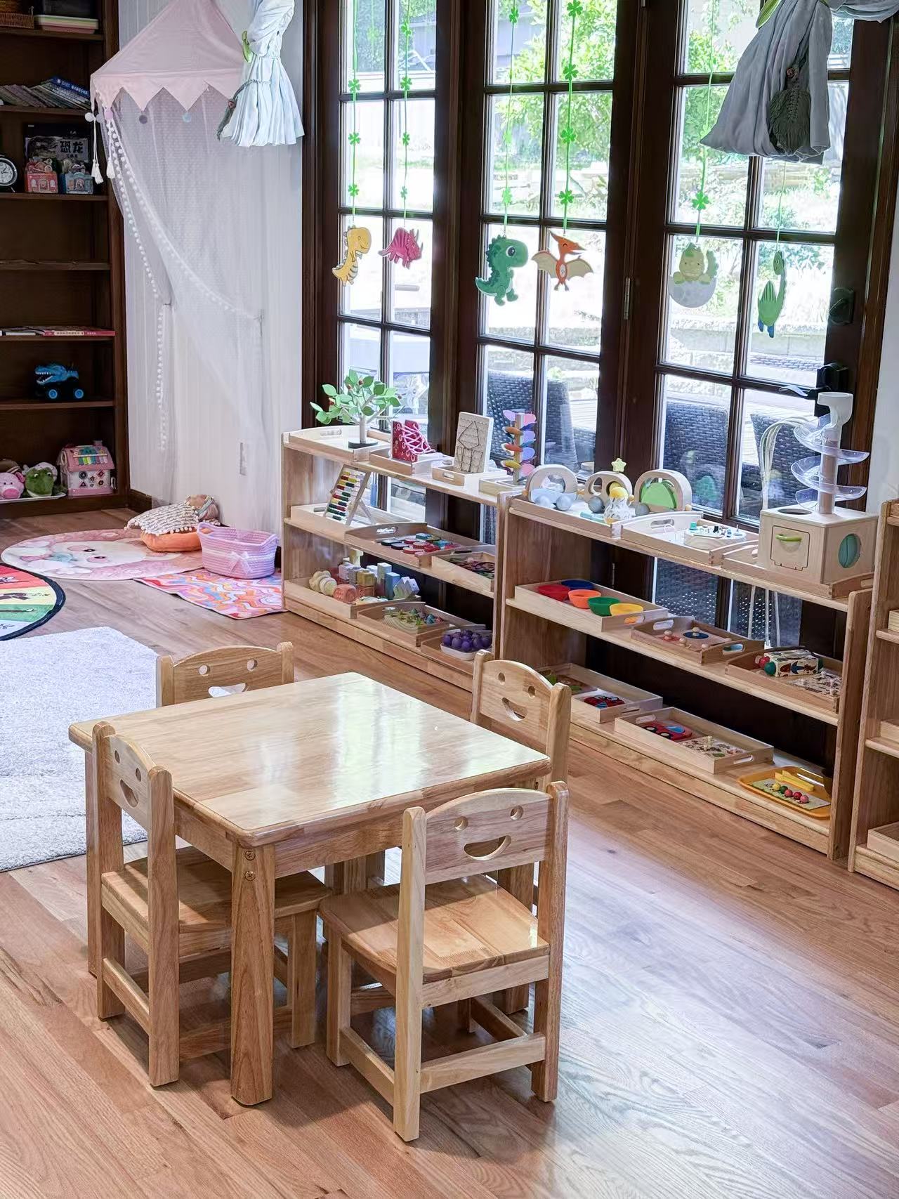 Wooden tables and learning materials beside the sunny windows